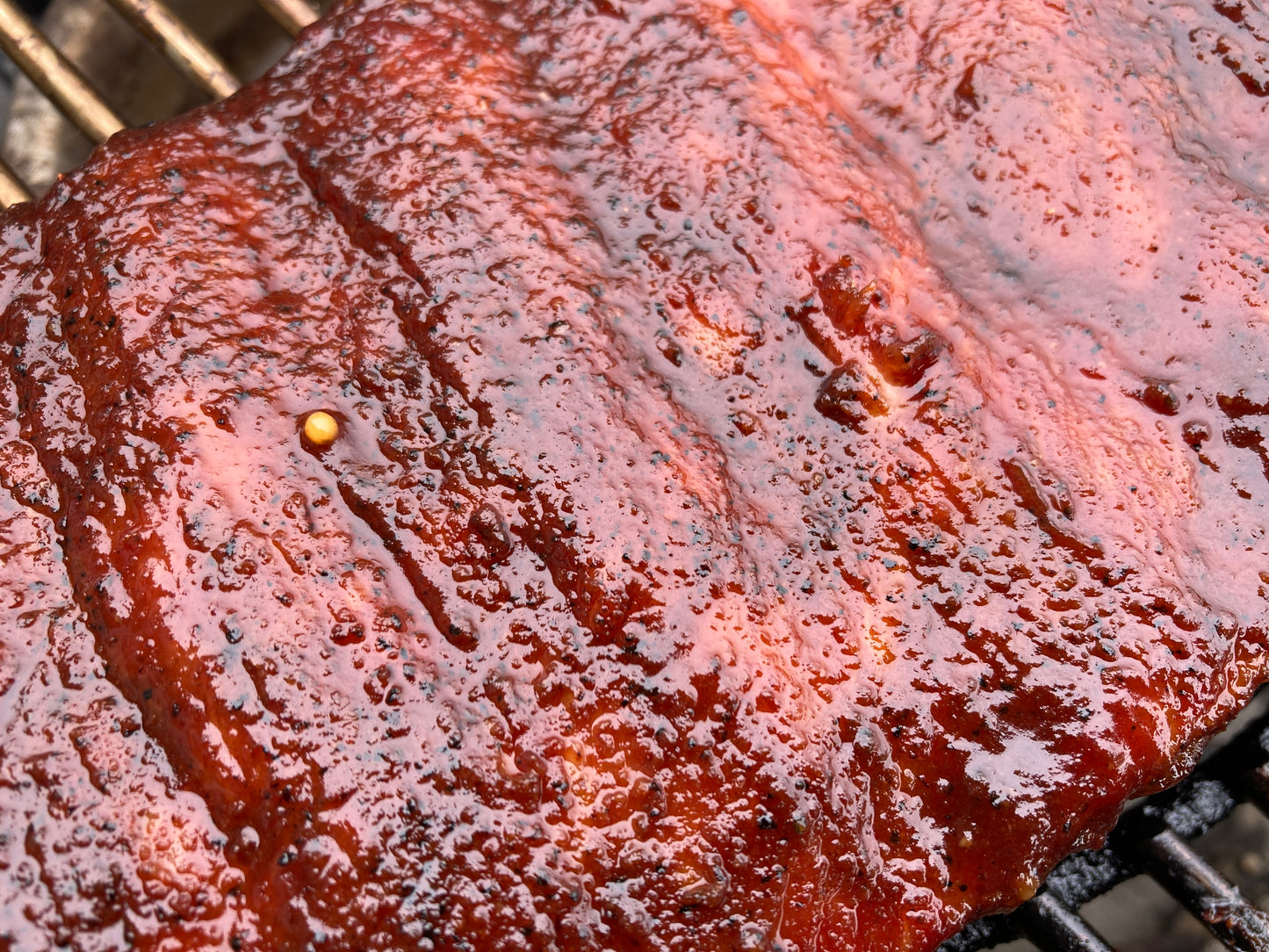 Close-up of a rib with barbecue sauce on a grill