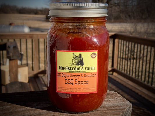 Jar of BBQ sauce with a label on a wooden surface outdoors